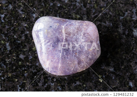 sample of tumbled cordierite mineral on black 129481232