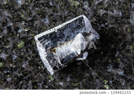 sample of raw ilvaite mineral on black granite sample of raw ilvaite mineral on black granite 129481233