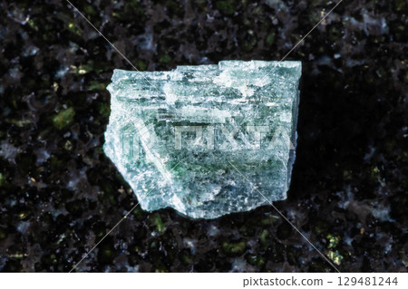 sample of rough indigolite mineral on black 129481244