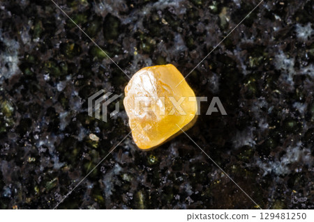raw jargoon zircon crystal on black granite raw jargoon zircon crystal on black granite 129481250