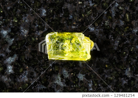 sample of unpolished vesuvianite crystal on black sample of unpolished vesuvianite crystal on black 129481254