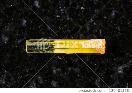 raw heliodor yellow beryl crystal on black 129481258