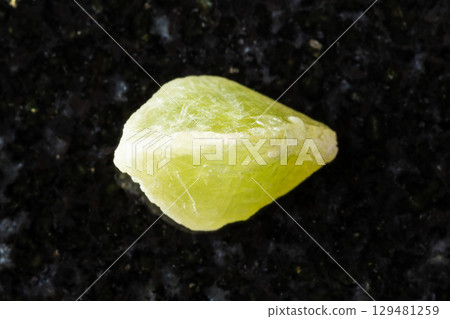sample of raw sphene crystal on black granite 129481259