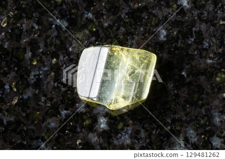 tumbled heliodor yellow beryl crystal on black 129481262