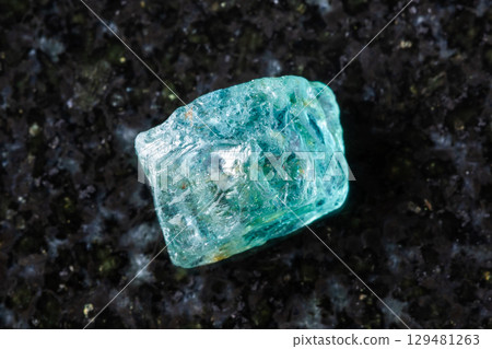 raw starlite blue zircon mineral on black granite raw starlite blue zircon mineral on black granite 129481263