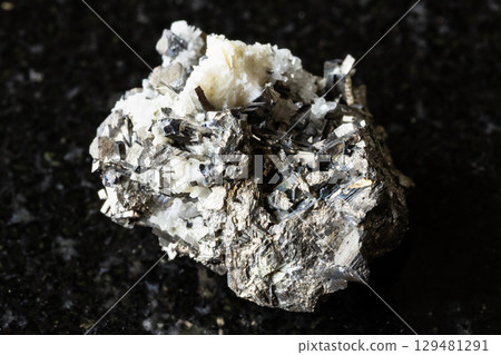 sample of raw arsenopyrite rock on black granite sample of raw arsenopyrite rock on black granite 129481291