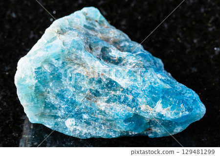 sample of rough apatite rock on black granite 129481299