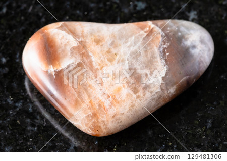 sample of polished nepheline rock on black granite 129481306