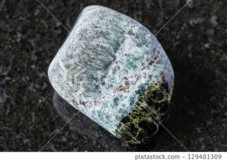 polished richterite and diopside mineral on black 129481309