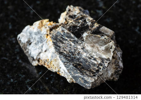 sample of rough anthraconite rock on black granite 129481314