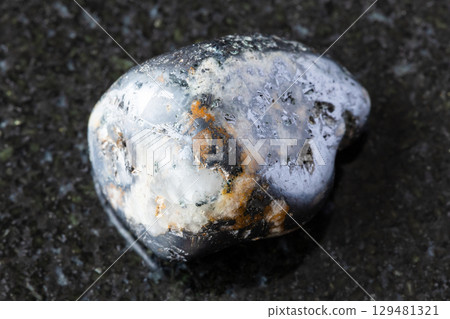 rolled cleiophane and mushketovite rock on black 129481321