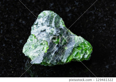 sample of rough chromian diopside rock on black 129481322