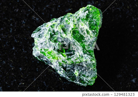 sample of raw chromian diopside rock on black 129481323