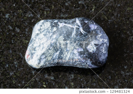 sample of polished antimonite mineral on black 129481324