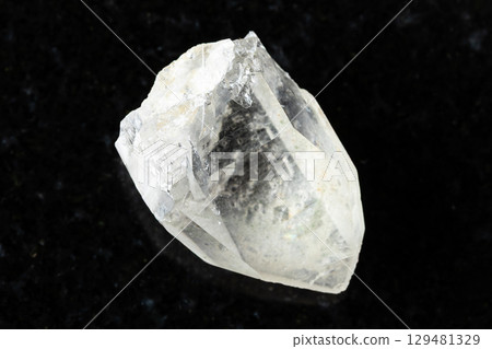 sample of rough rock-crystal on black granite 129481329