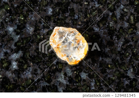 sample of rough colorless sapphire on black 129481345