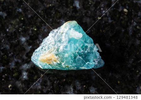 sample of raw grandidierite crystal on black 129481348