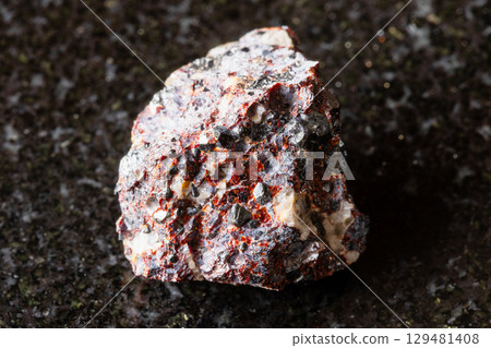 rough franklinite and zincite rock on black 129481408