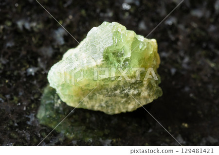 sample of rough yellow green beryl rock on black sample of rough yellow green beryl rock on black 129481421