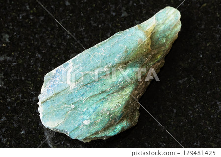 sample of rough green labradorite rock on black 129481425