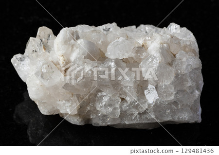 sample of rough druse of quartz rock on black 129481436