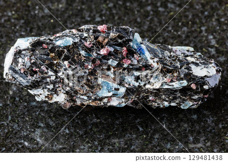 sample of rough kyanite in biotite rock on black sample of rough kyanite in biotite rock on black 129481438