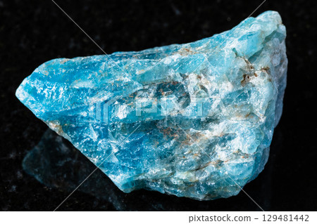 sample of rough apatite mineral on black granite sample of rough apatite mineral on black granite 129481442