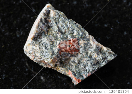 sample of raw gneissoid granite rock on black 129481504