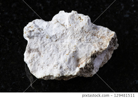 sample of rough albite rock on black granite sample of rough albite rock on black granite 129481511