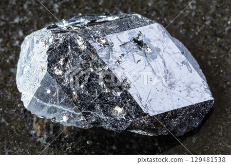 rough melanite andradite garnet crystal on black 129481538