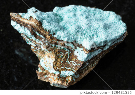 sample of raw aurichalcite rock on black granite 129481555