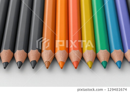 A variety of colored pencils are carefully aligned in a row, showcasing vibrant colors from black to green. The sharpened tips glisten under soft light, inviting creativity for artistic projects. A variety of colored pencils are carefully aligned in a row, showcasing vibrant colors from black to green. The sharpened tips glisten under soft light, inviting creativity for artistic projects. 129481674