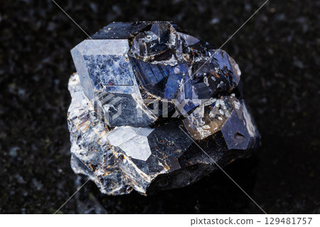 sample of rough black andradite garnet on black 129481757