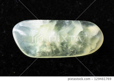 sample of tumbled vesuvianite mineral on black 129481769