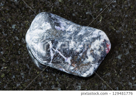 sample of polished antimonite rock on black 129481776