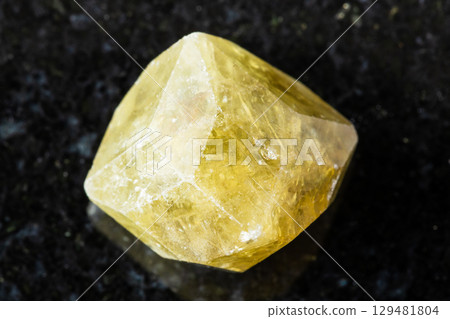 rough green grossular garnet crystal on black 129481804