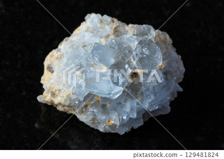 sample of rough celestine rock on black granite 129481824