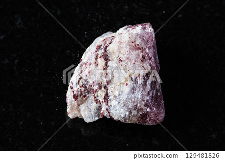 sample of raw strawberry quartz rock on black 129481826