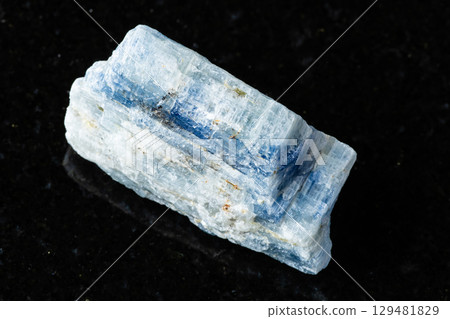 sample of uncut kyanite rock on black granite 129481829