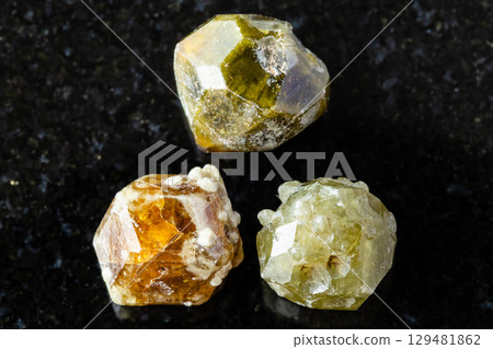 sample of three grossular garnet crystals on black 129481862