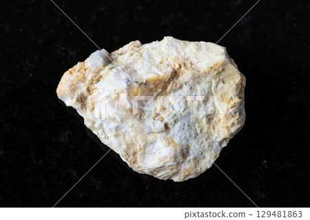 sample of rough xonotlite mineral on black granite 129481863