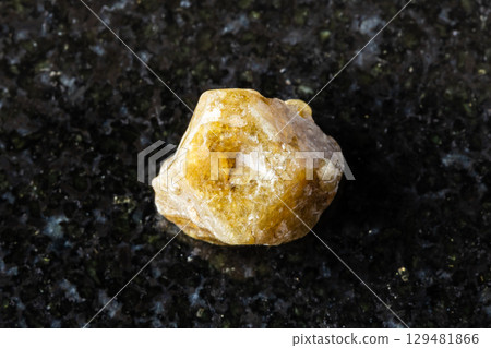 raw single green grossular garnet crystal on black raw single green grossular garnet crystal on black 129481866
