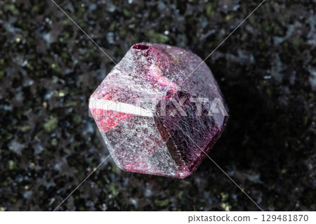 sample of rough rhodolite pyrope crystal on black sample of rough rhodolite pyrope crystal on black 129481870