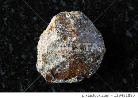 sample of rough brown titanite mineral on black 129481880