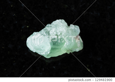 sample of rough herderite mineral on black granite 129481900