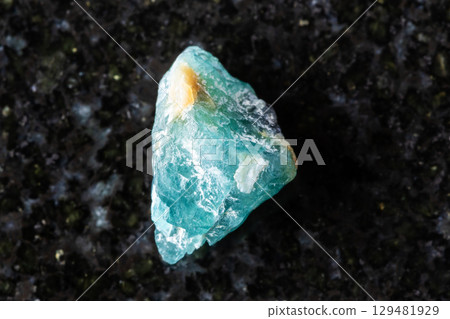 sample of unworked grandidierite crystal on black 129481929