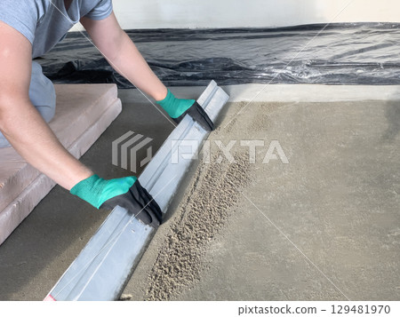 Smooth cement screeding process indoors 129481970
