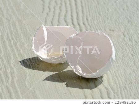 Cracked Eggshells with Yolk on Table Cracked Eggshells with Yolk on Table 129482180