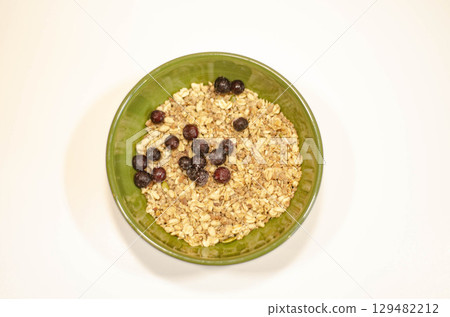 Close Up of Granola with Huckleberries in Green Bowl 129482212