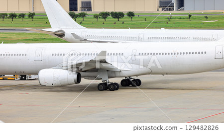 Clear picture of unpainted airliner engine and main landing gear. 129482826